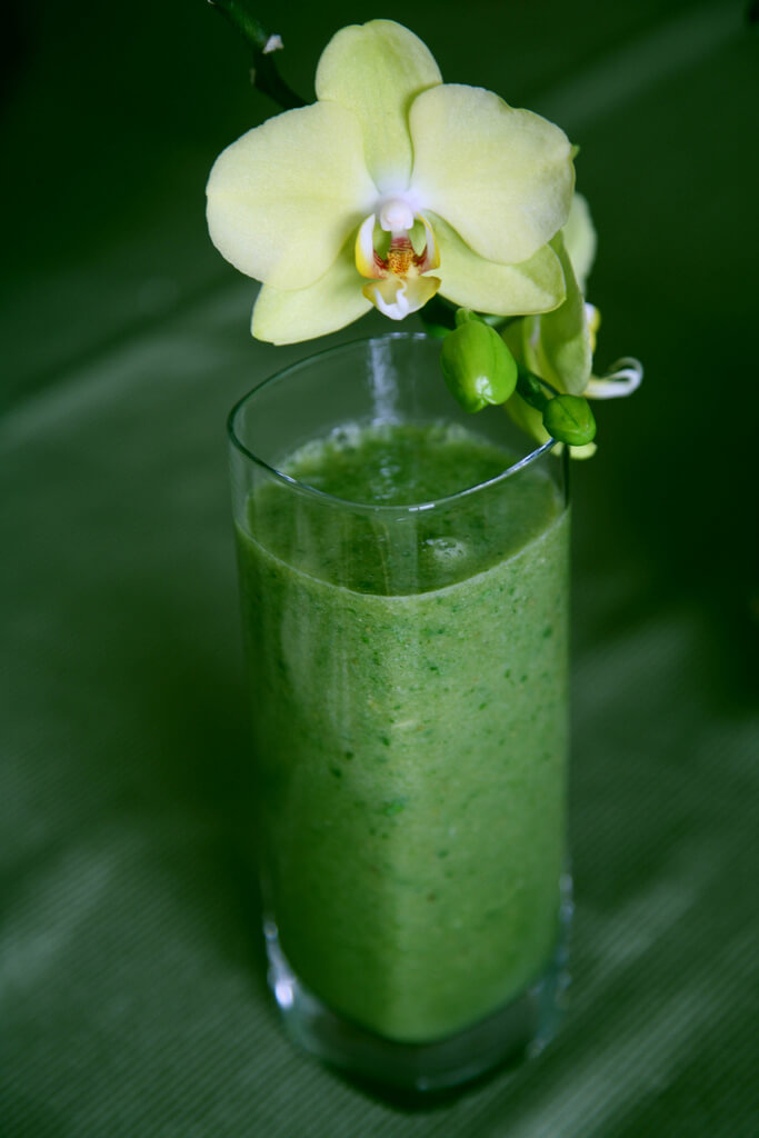 a green smoothie with a flower to represent alcohol free drinks