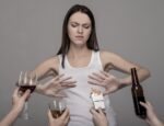 Woman rejecting many kinds of alcoholic drinks